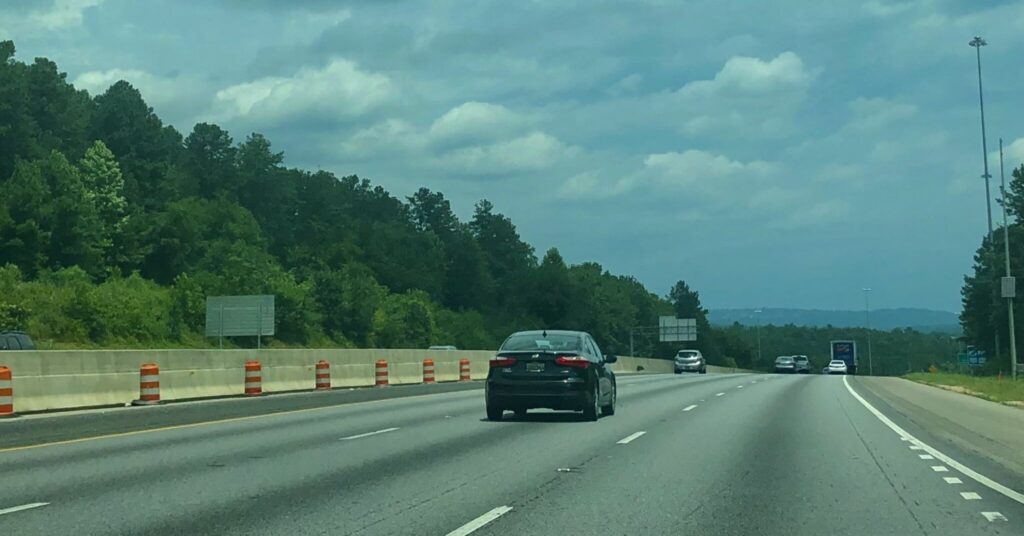 a car driving on a highway lane closures