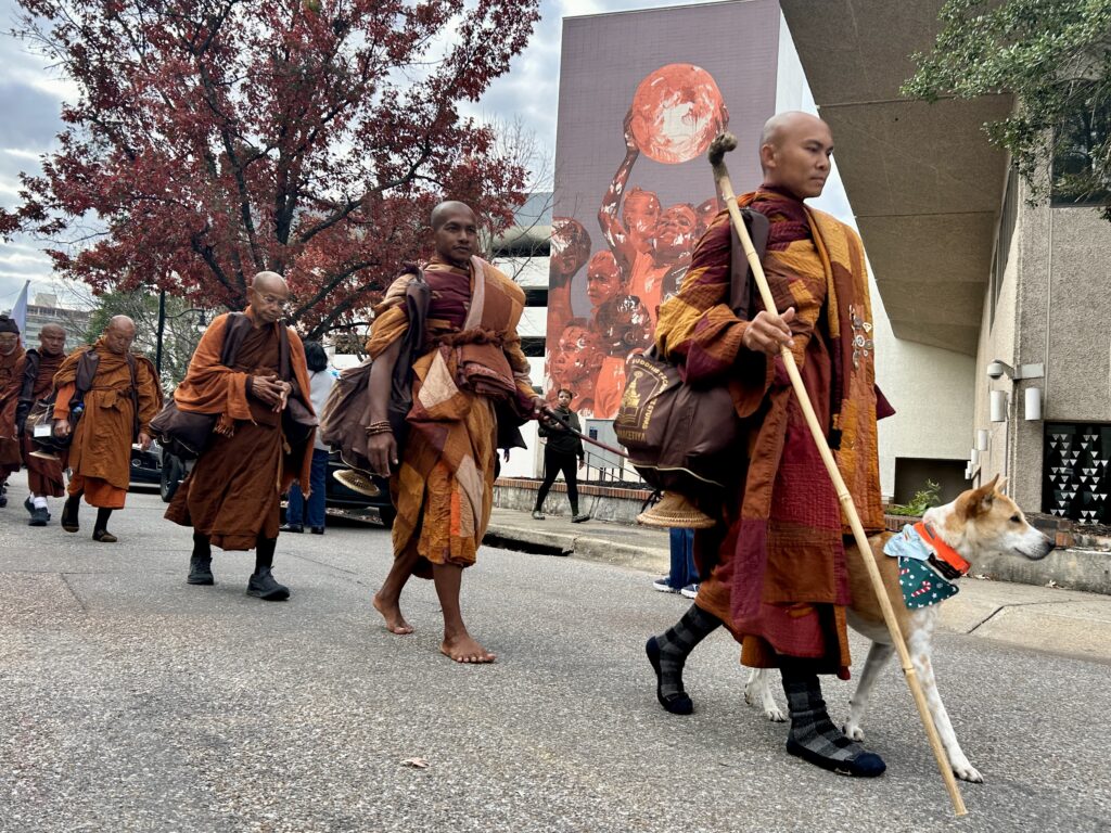 PHOTOS: Walk for Peace monks make extended stop in Montgomery 4 Monks walking with a dog