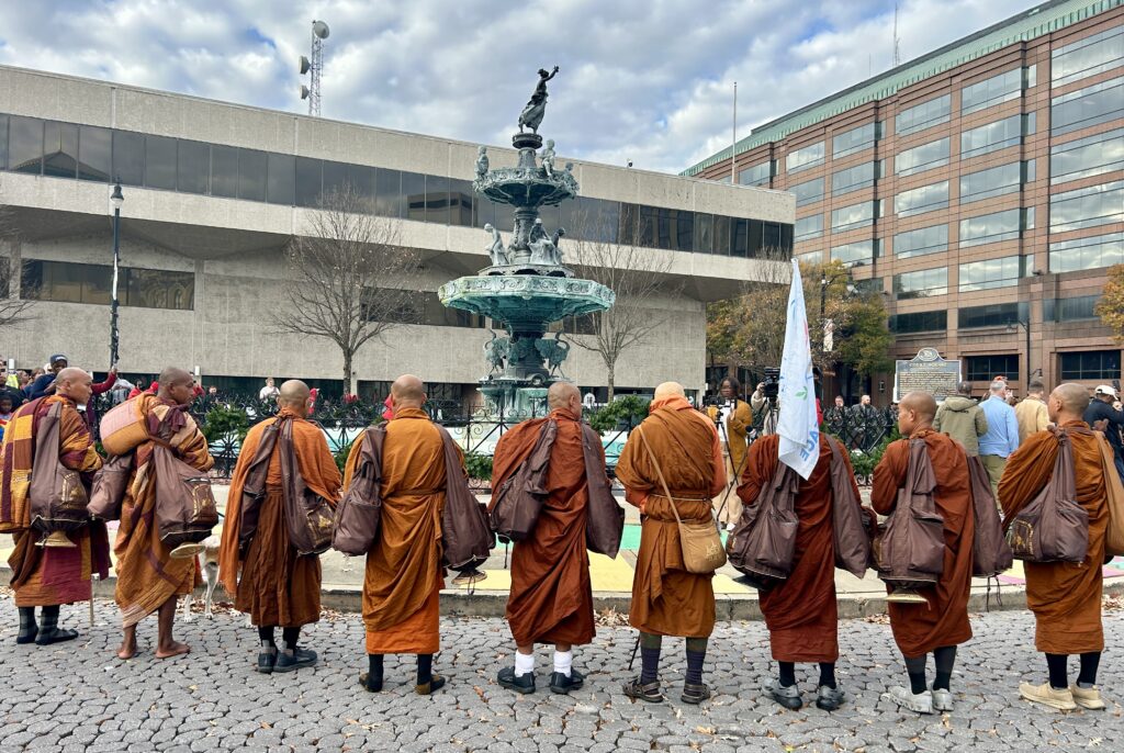 PHOTOS: Walk for Peace monks make extended stop in Montgomery 5 Monks gathering near a fountain.