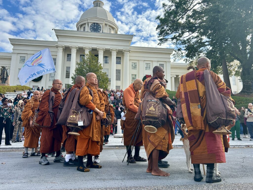 PHOTOS: Walk for Peace monks make extended stop in Montgomery 1 Monks gathered near a building.