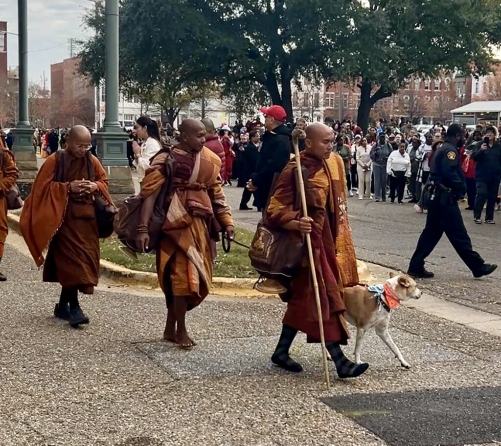 PHOTOS: Walk for Peace monks make extended stop in Montgomery 3 monks wearing red and orange walk on a road with their dog